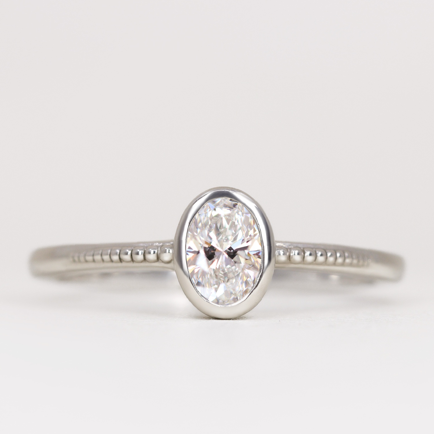 Nina Oval Cut Bezel Set Beaded Solitaire Engagement Ring