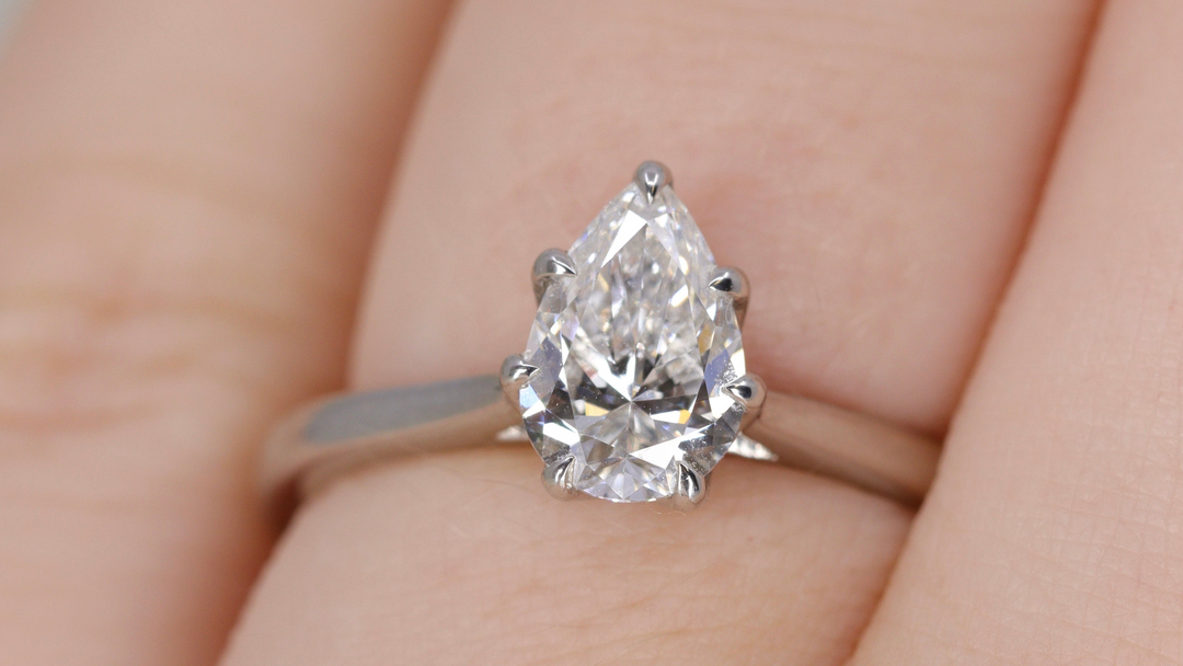 Pear-shaped diamond ring on a finger