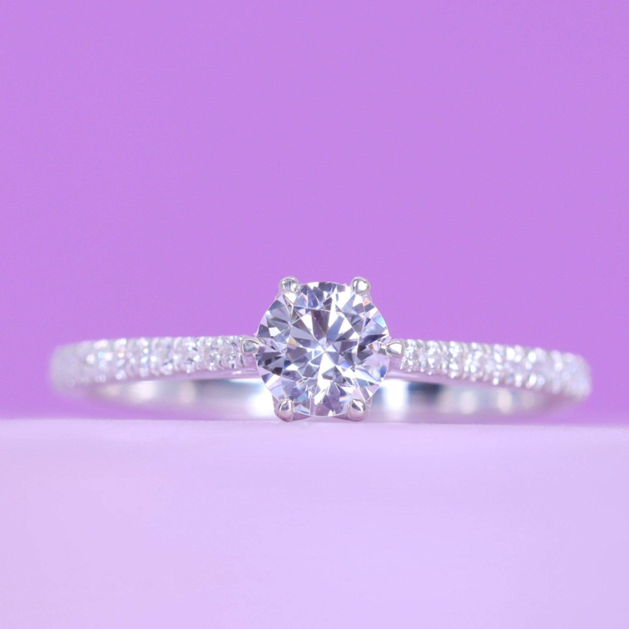 Raine Round Brilliant Cut White Diamond Solitaire Ring with Lotus Fl