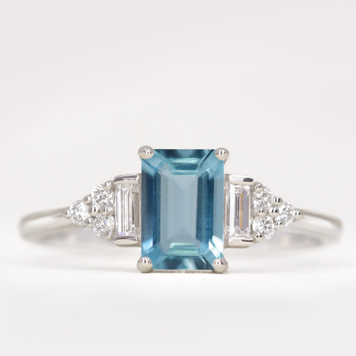 Art deco emerald cut aquamarine engagement ring with white diamond side stones