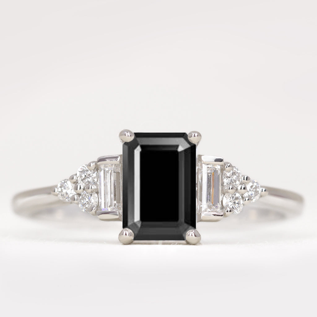 Emerald cut black diamond engagement ring with white diamond side stones