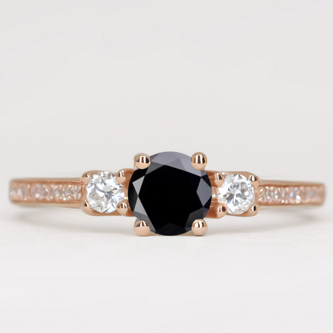 Round cut black diamond and white diamond trilogy engagement ring with white diamond pave band