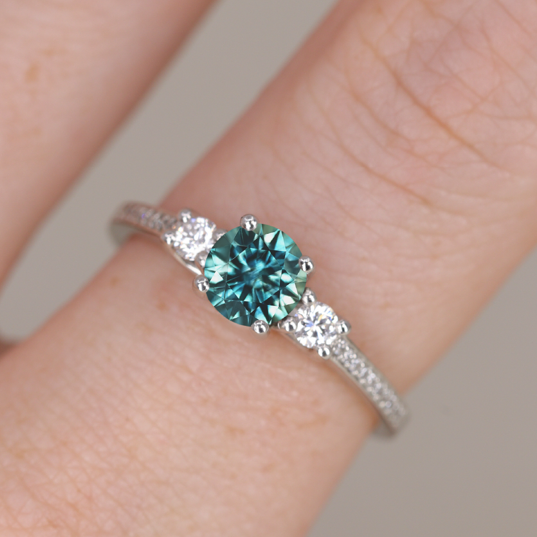 Callie - Round Brilliant Cut Teal Sapphire Delicate Trilogy Engagement Ring