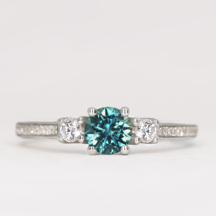 Callie - Round Brilliant Cut Teal Sapphire Delicate Trilogy Engagement Ring
