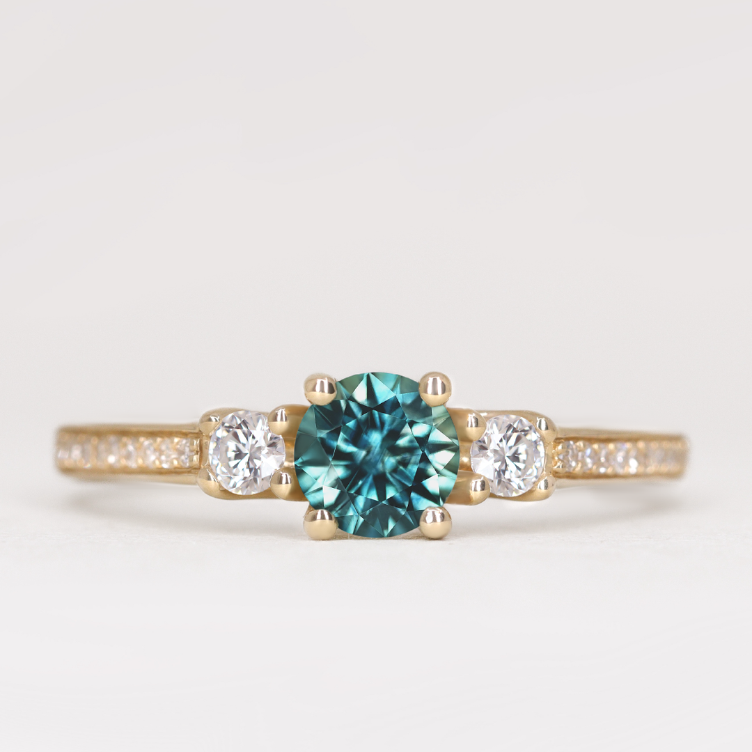 Callie - Round Brilliant Cut Teal Sapphire Delicate Trilogy Engagement Ring