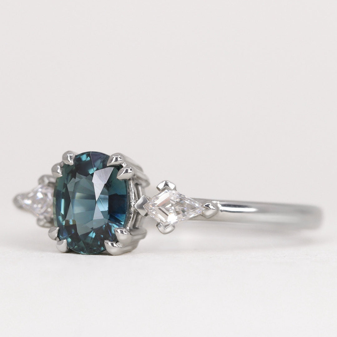 oval cut teal sapphire engagement ring with white diamonds