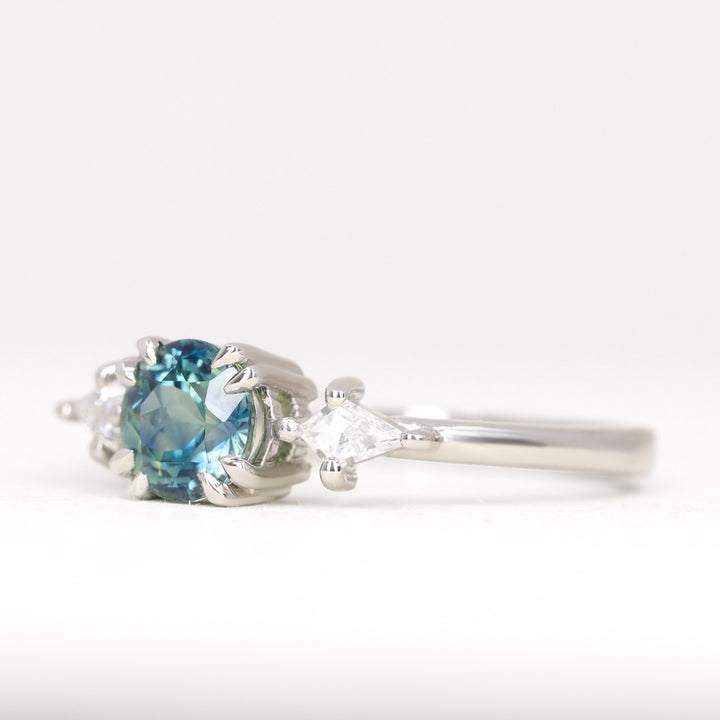 Teal sapphire engagement ring in platinum