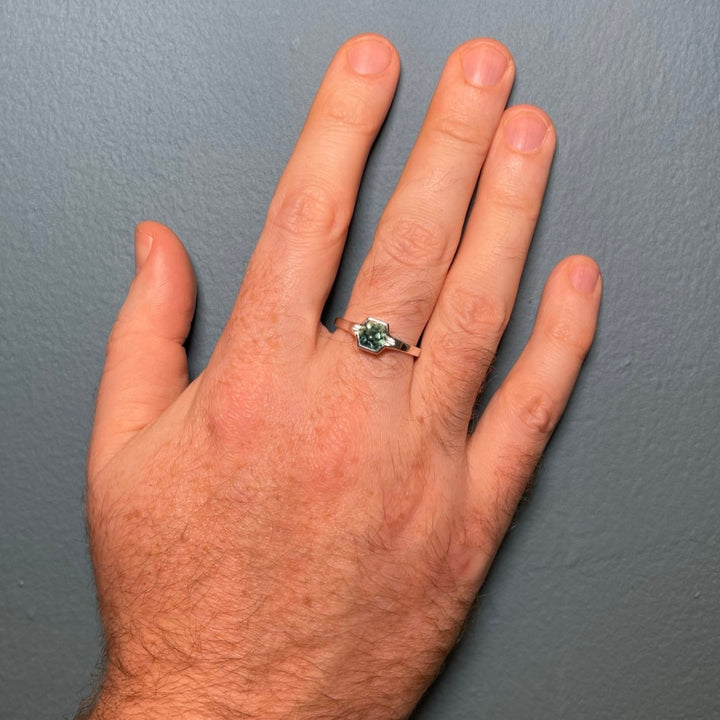 Unique gender neutral engagement ring with teal sapphire