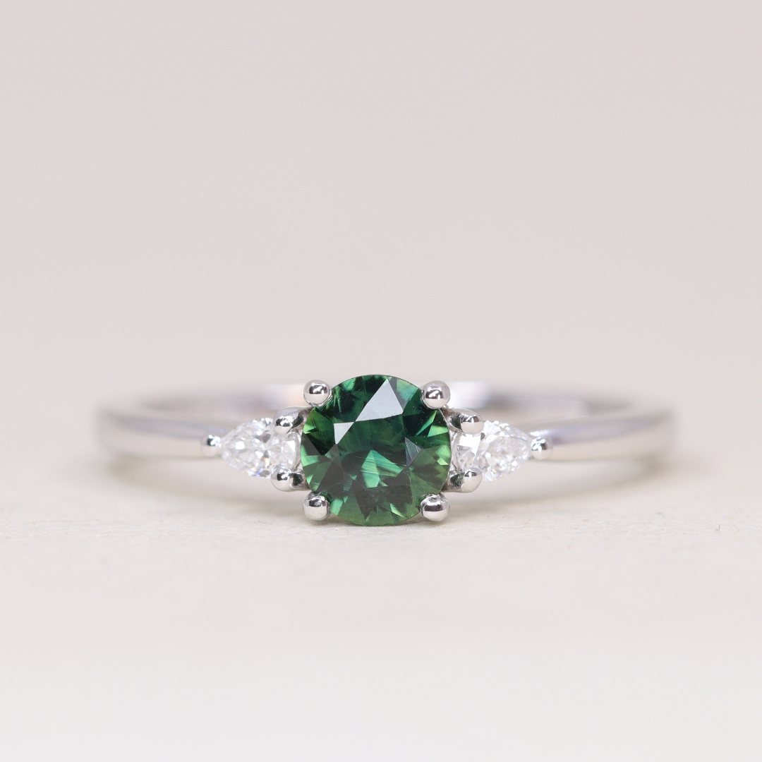 Elspeth - Round Cut Green Teal Sapphire Trilogy Engagement Ring - Ready-to-Wear Engagement Rings - Ready-to-Ship