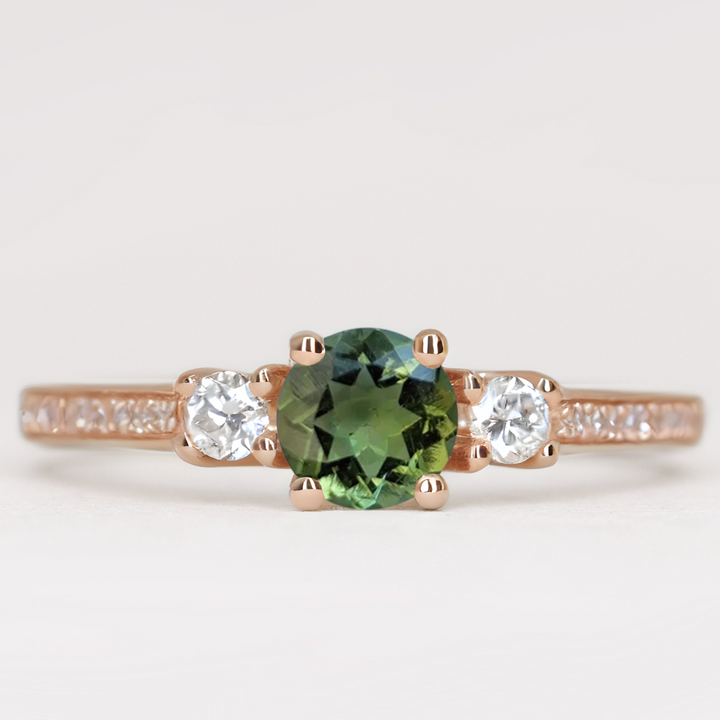 Round cut tourmaline and diamond trilogy engagement ring with white diamond pave band