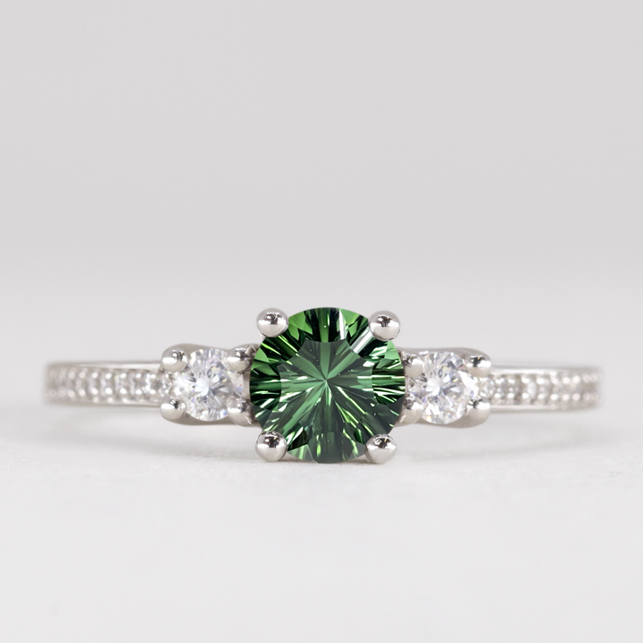 Round cut tourmaline and diamond trilogy engagement ring with white diamond pave band