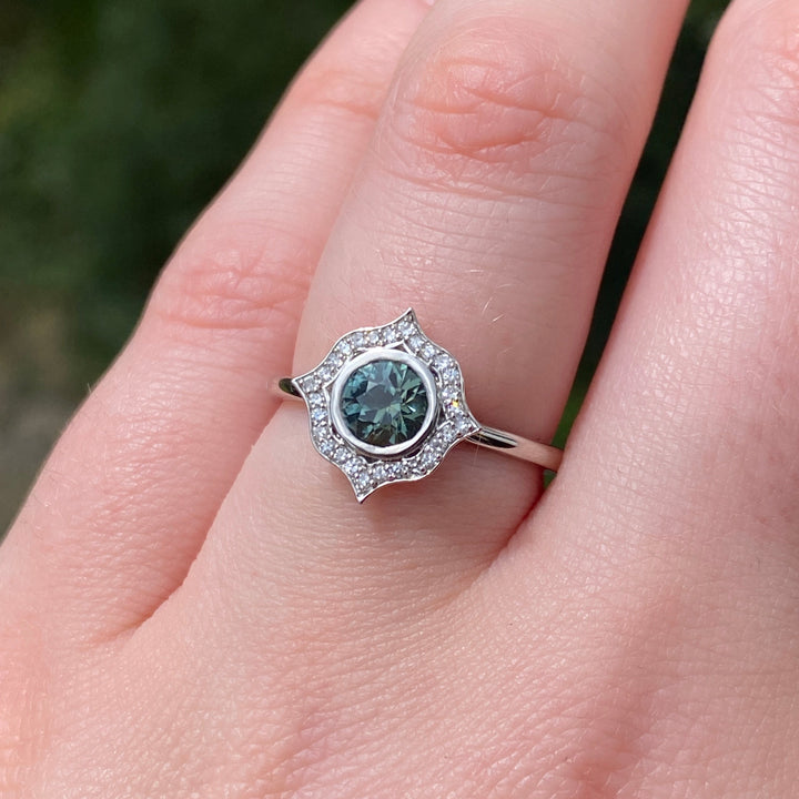 Antonia - The Botanicals Collection - Round Brilliant Cut Teal Sapphire Bezel Rubover Set Art Nouveau Halo Engagement Ring In Platinum - Ready-To-Wear