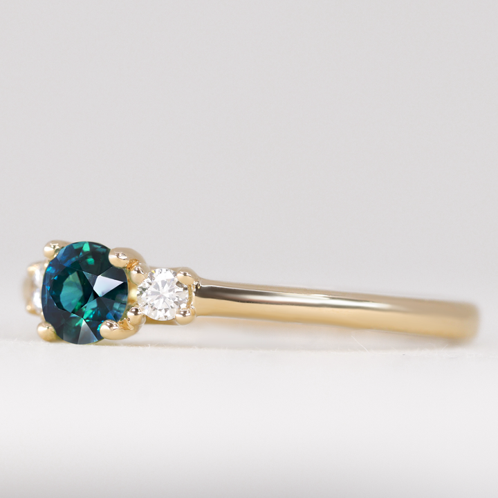 Millie - Round Brilliant Cut Teal Sapphire and Diamond Trilogy Engagement Ring