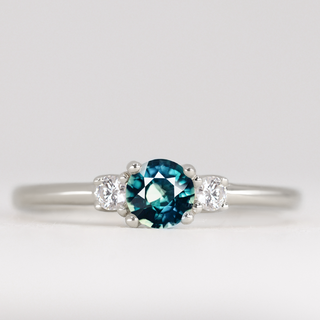 Millie - Round Brilliant Cut Teal Sapphire and Diamond Trilogy Engagement Ring