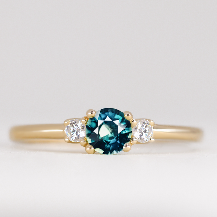 Millie - Round Brilliant Cut Teal Sapphire and Diamond Trilogy Engagement Ring