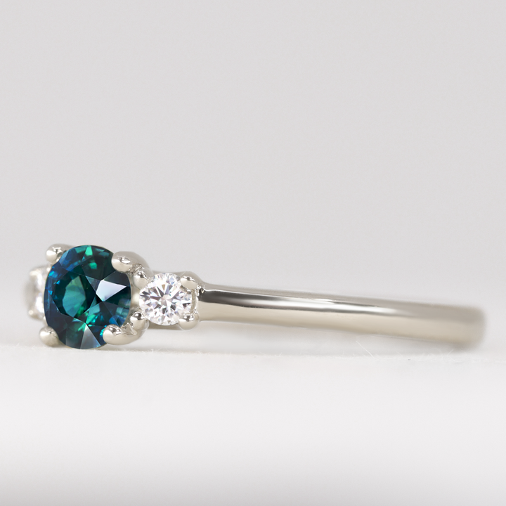 Millie - Round Brilliant Cut Teal Sapphire and Diamond Trilogy Engagement Ring
