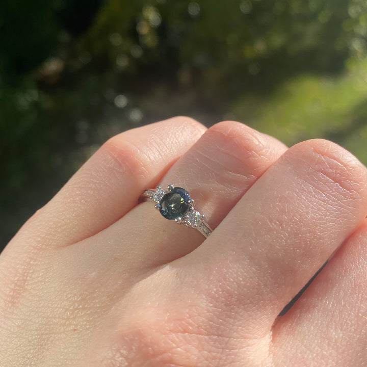 Oval sapphire and white diamond trilogy ring with pave platinum band