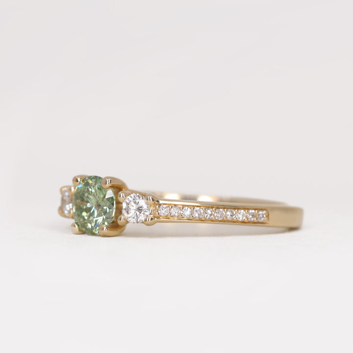 Round green diamond and white diamond pave  yellow gold band engagement ring