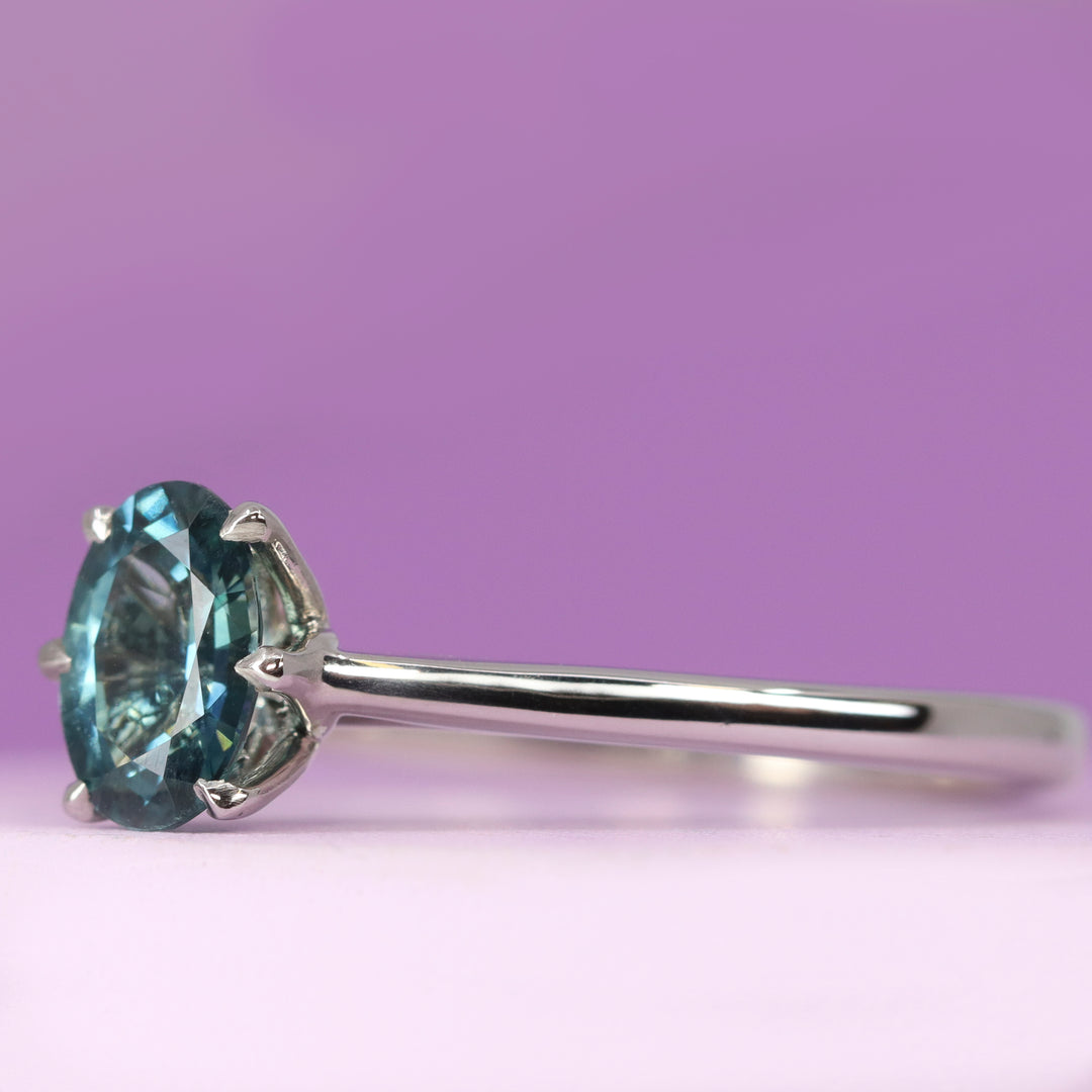 Raine - Oval Cut Teal Sapphire Solitaire Ring with Lotus Flower Inspired Setting in Platinum- Ready-to-Wear