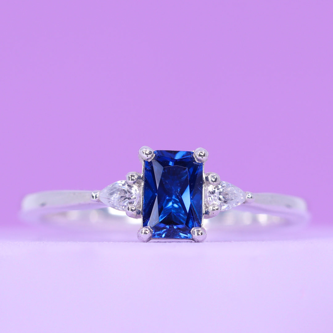 Elspeth - Radiant Cut Royal Blue Sapphire and Pear Shaped Lab Grown Diamond Trilogy Engagement Ring - Made-to-Order
