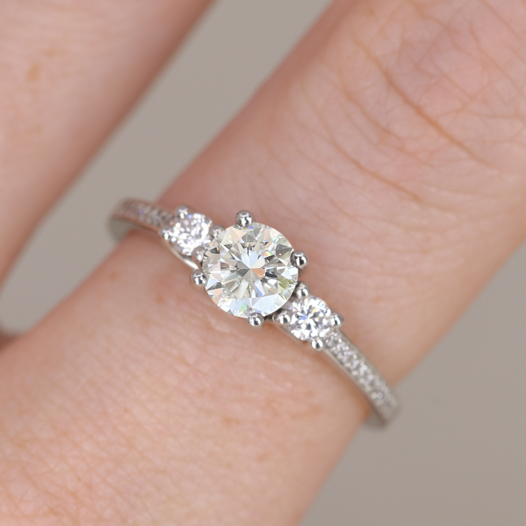 Round white diamond and white diamond pave platinum band engagement ring