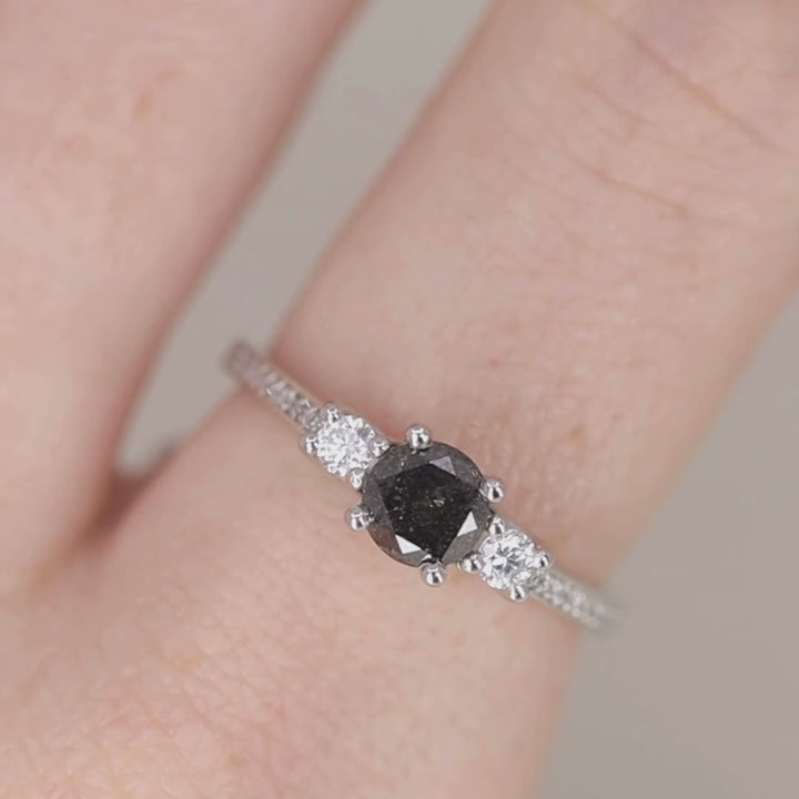 Round cut unique dark salt and pepper diamond trilogy engagement ring with pave band